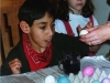 Jose dying Easter eggs as his cousin Barbara looks on
