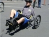 Kolya rides a specially built bike which he steers by leaning and can brake without the use of hand brakes